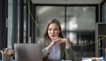 Business women reviewing information on laptop