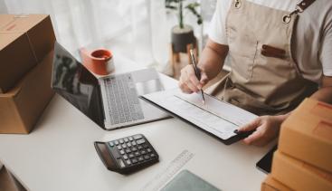 Merchant reviewing paperwork at desk