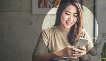 Woman looking at phone happily