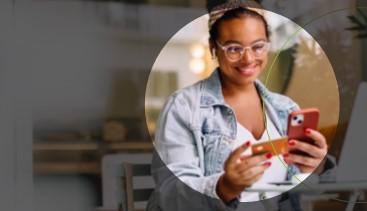 Woman making a purchase on her phone with her credit card